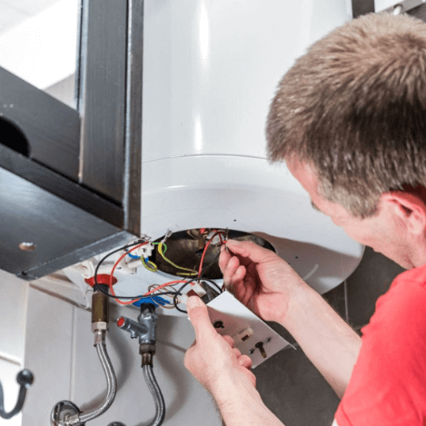plumber fixing electric hot water system